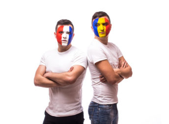 France vs Romania preview on white background. Football fans of Romania national team look at fan of France national teams. football fans concept.